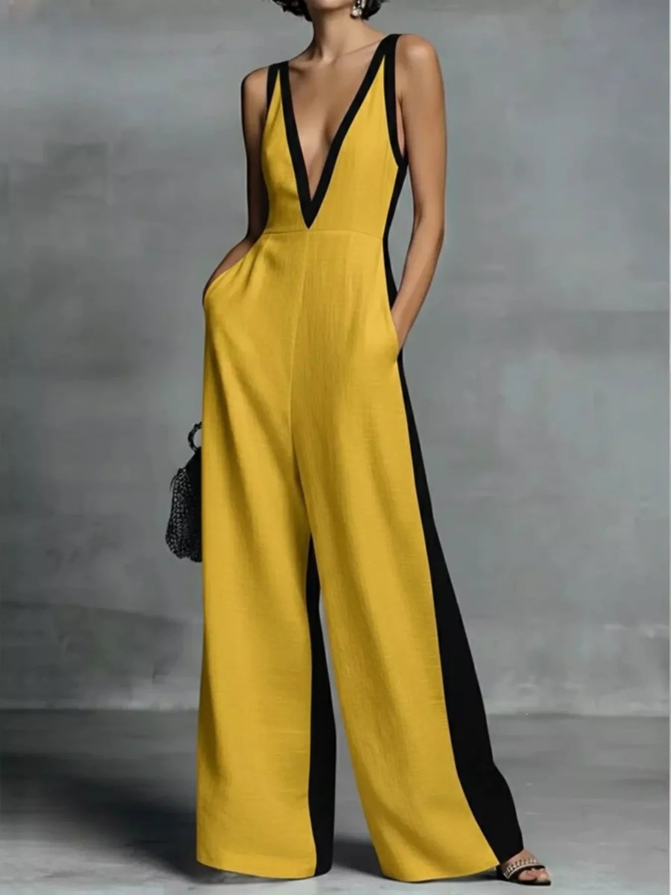 Yellow deep V-neck wide-leg jumpsuit with black contrast trim, sleeveless