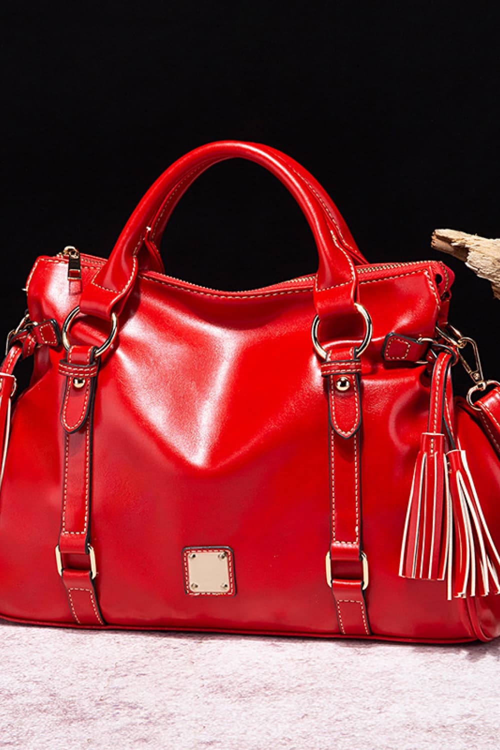 Red PU leather handbag with tassels, top handles, front square logo patch
