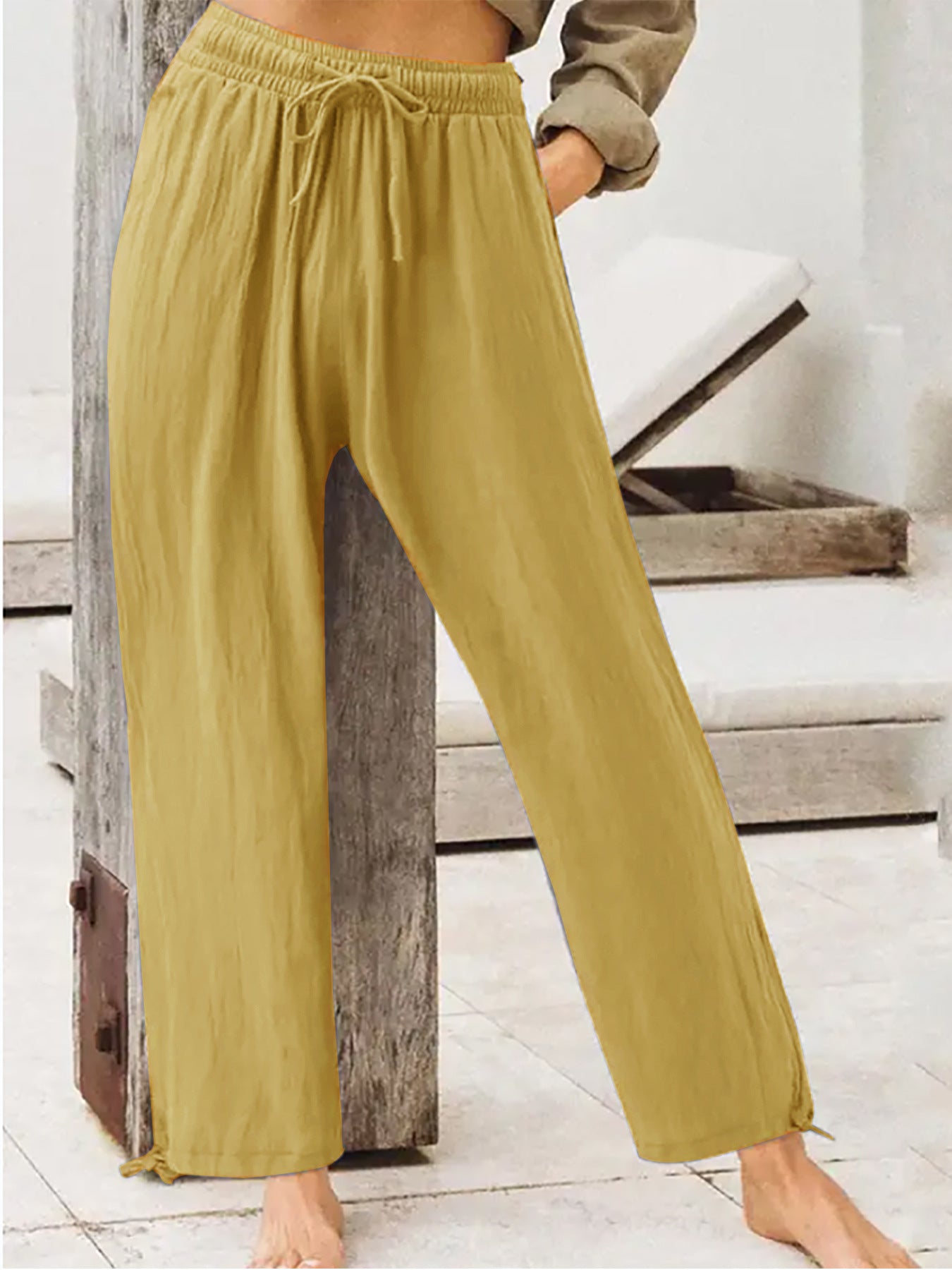 Women's wide-leg drawstring pants in mustard yellow, elastic waist, relaxed fit.