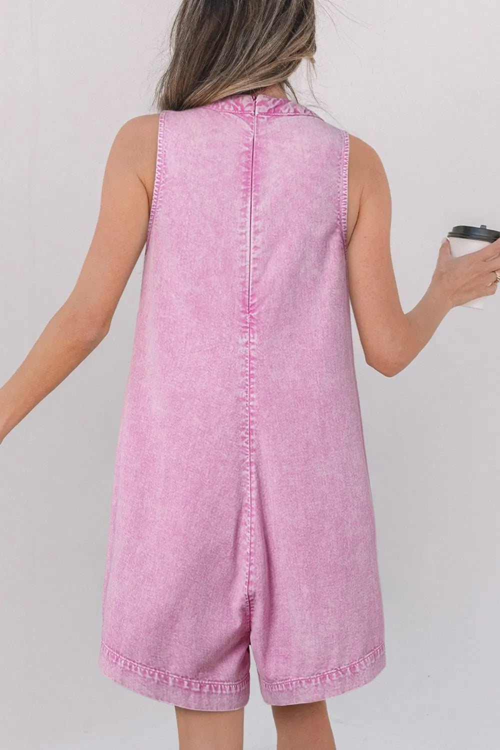 Pink mineral-wash denim romper back view, sleeveless with keyhole and vertical seam