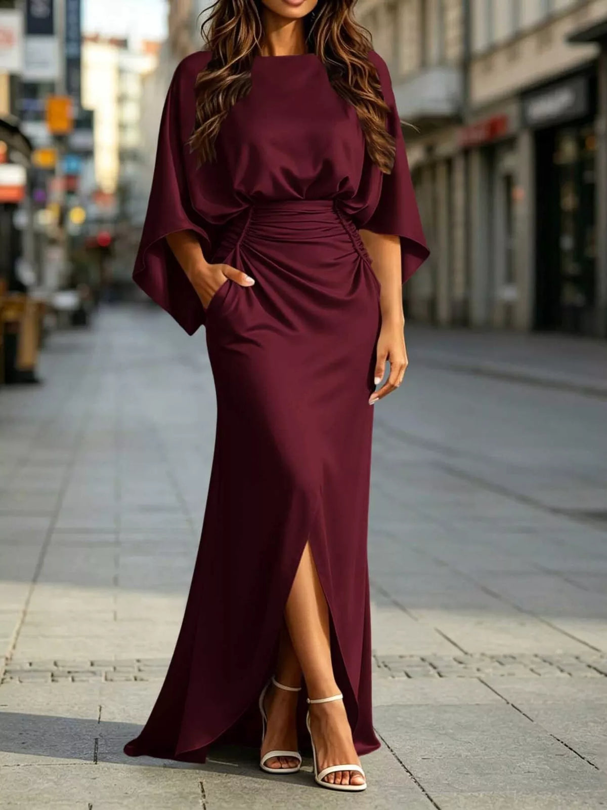 Burgundy satin maxi dress with ruched waist, dolman sleeves, and front slit