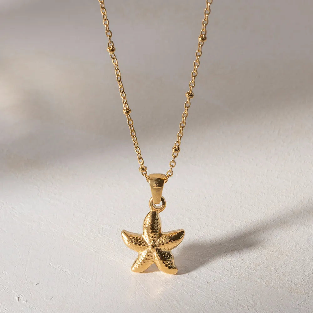 Gold-plated starfish pendant necklace with starfish charm and rounded connector bail