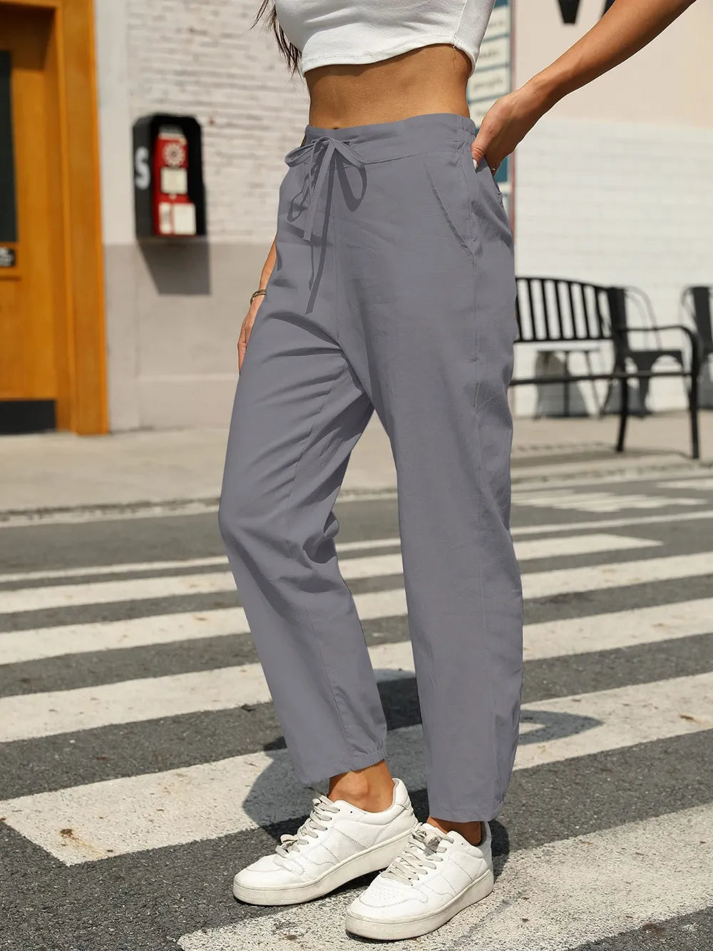 Gray tapered pants with elastic waist and front drawstring tie