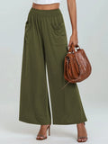 Moss green wide-leg pants with elastic waist and side pockets, cropped view from front
