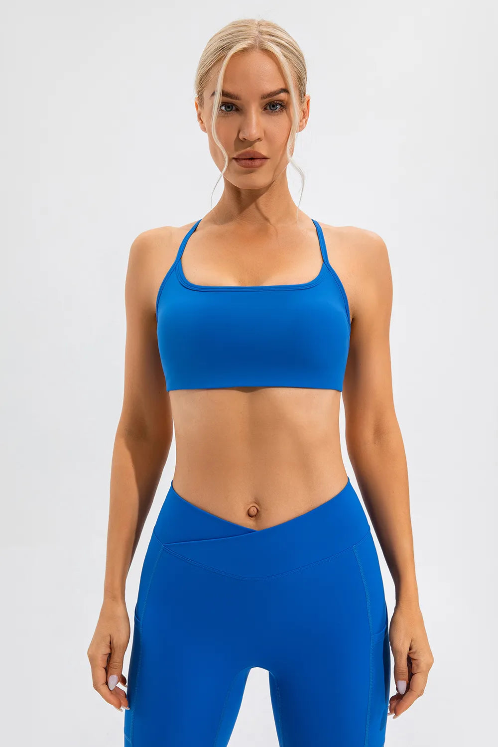 Blue active cami with scoop neckline and racerback-style straps, cropped fit