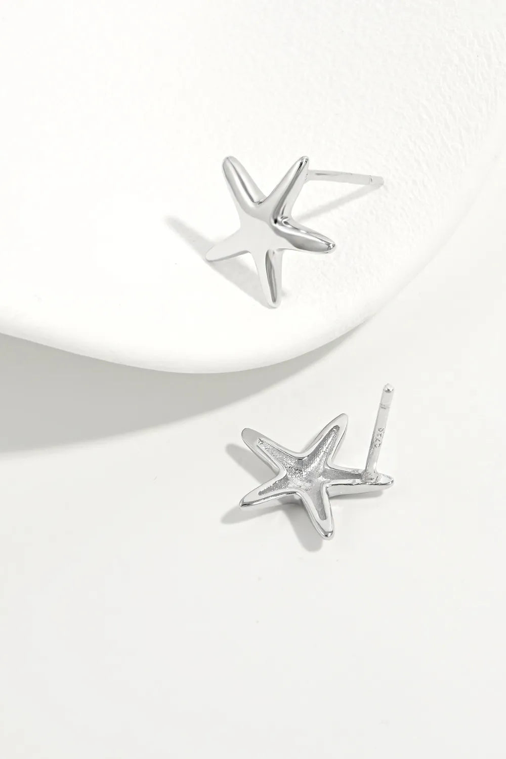Sterling silver star stud earrings, angled view showing earring posts