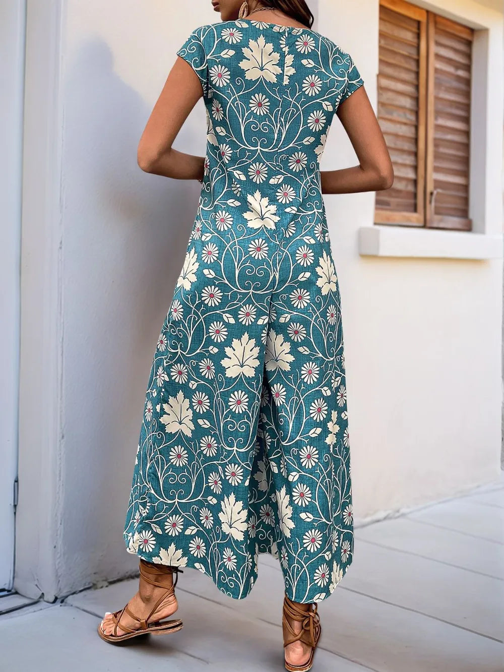 Turquoise printed wide-leg jumpsuit with round neck and cap sleeves, back view