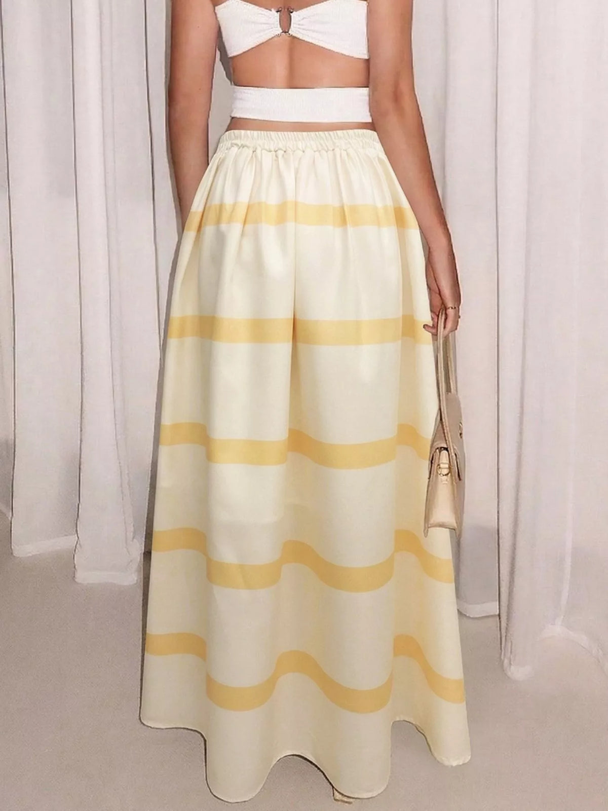 Yellow and white striped maxi skirt with elastic waist and side pockets