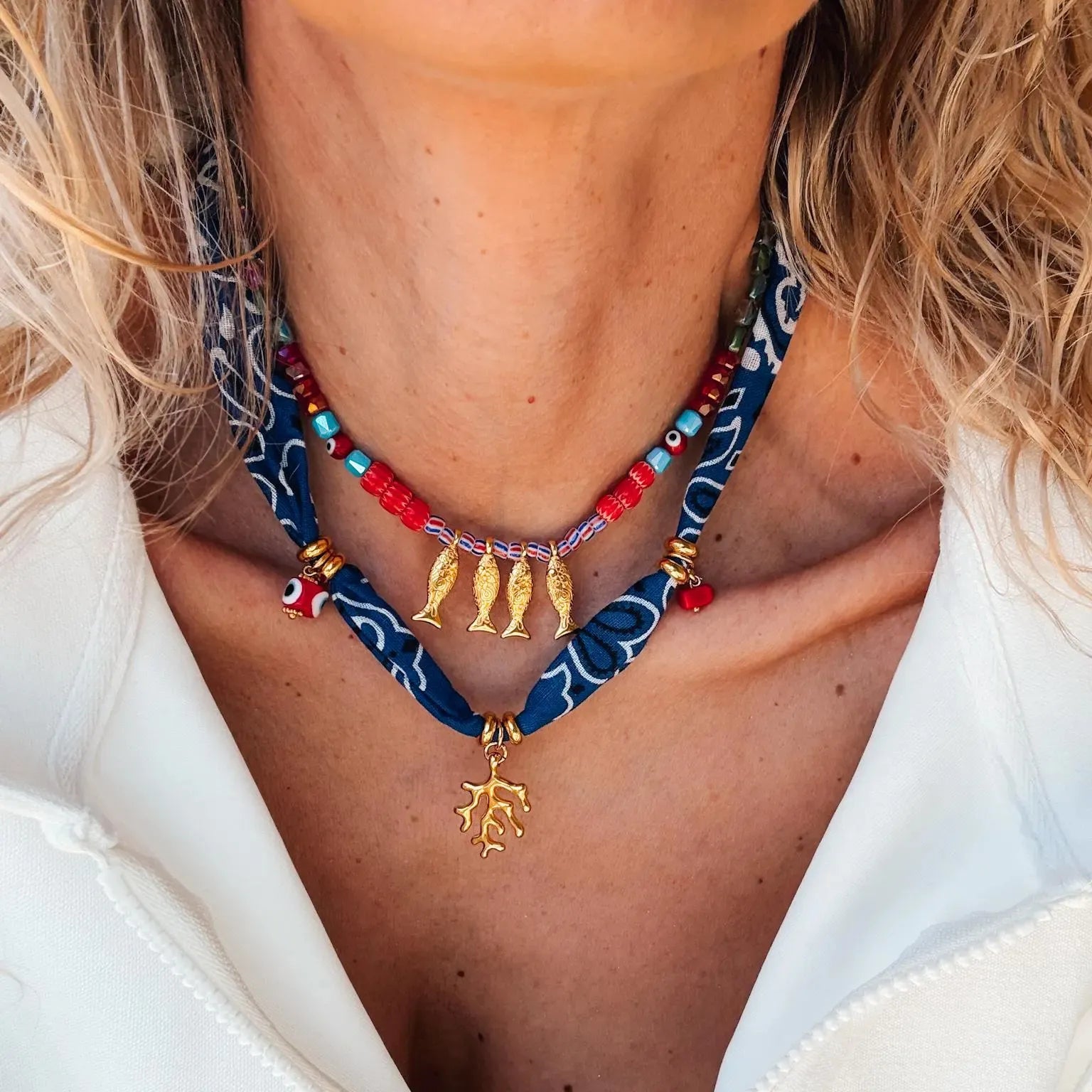2-piece necklace with gold fish pendant on navy patterned bead cord