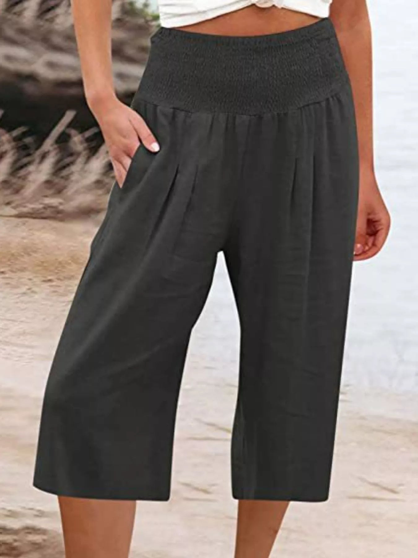Smocked wide-leg capri pants in black, elastic waist and loose wide cropped legs