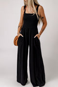 Black smocked square-neck jumpsuit with wide legs and side pockets