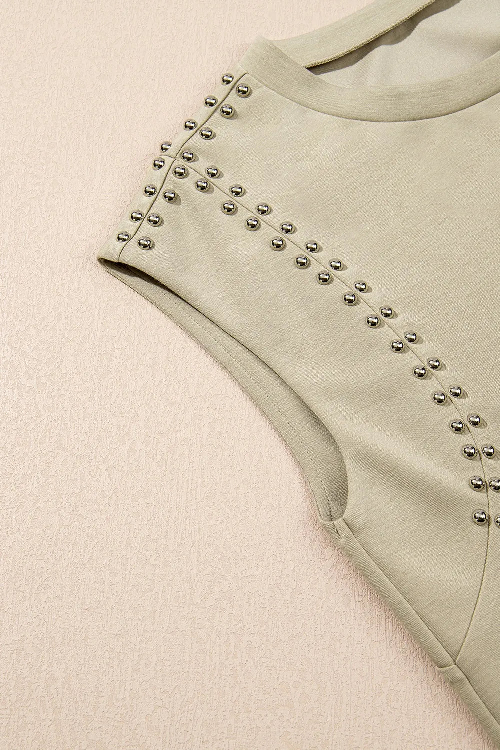 Cedar & Moore Studded cap sleeve round-neck tee in beige with silver studs along the sleeve seam, Trendsi.