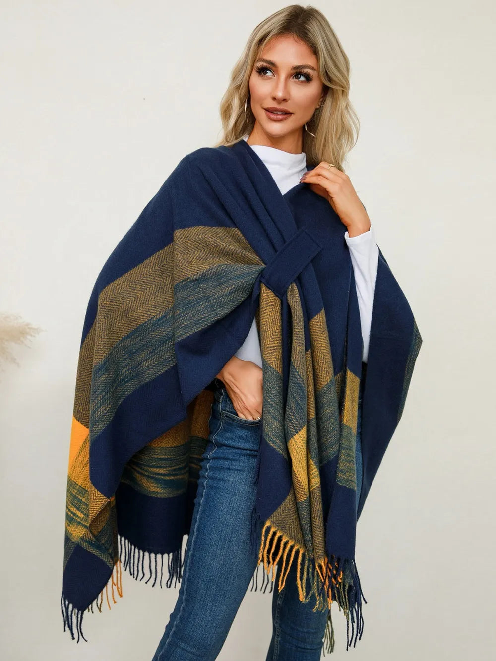 Fringe plaid poncho in navy with olive and gold striped blocks and tassel fringe