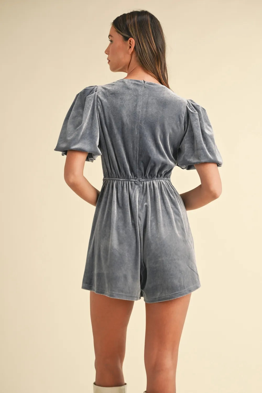 Dusty blue velvet romper with puff sleeves and gathered waist, back view