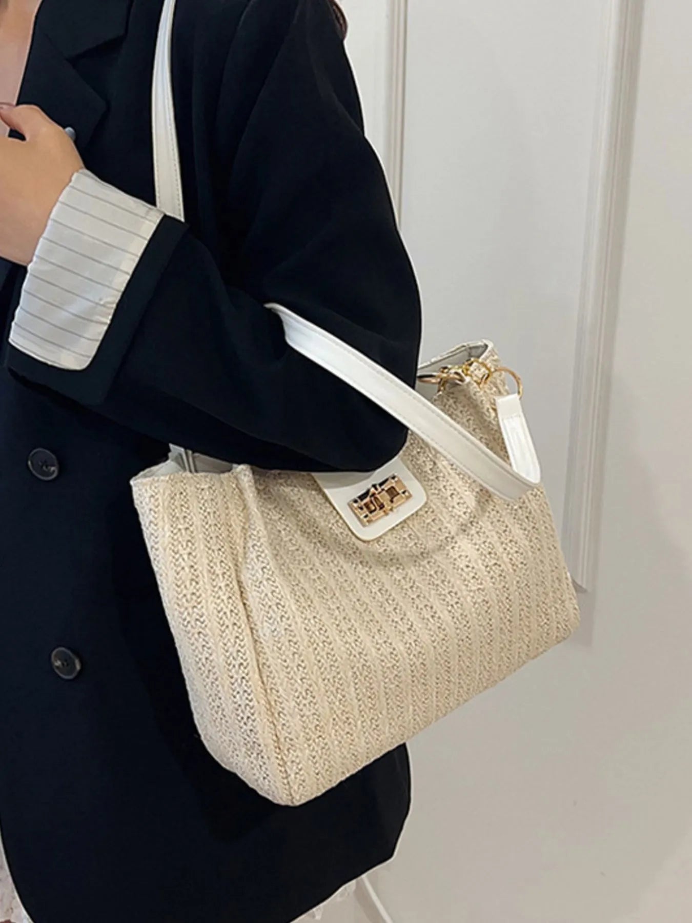 Beige woven straw shoulder bag with white strap and small square front clasp
