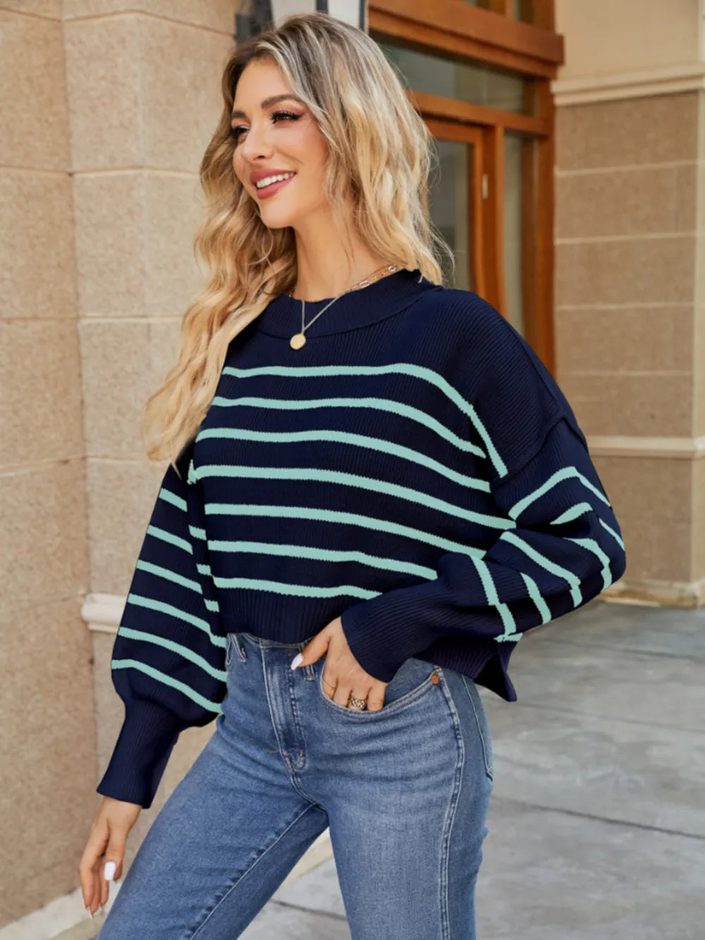 Navy round-neck striped sweater with light blue bands and ribbed lantern cuffs