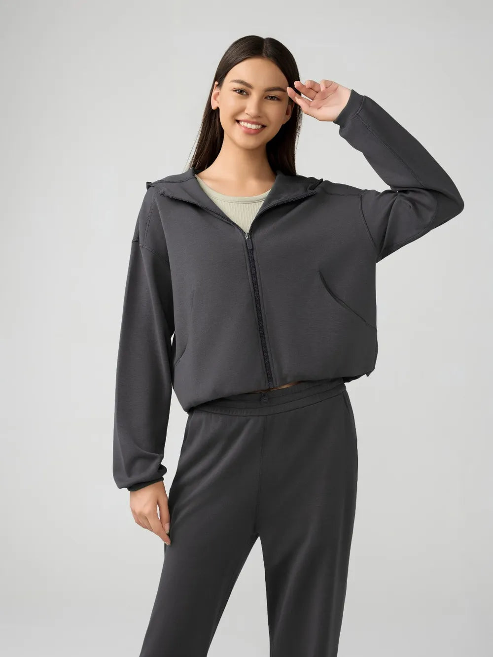 Dark gray hooded zip-up active jacket with dropped shoulders and front zipper