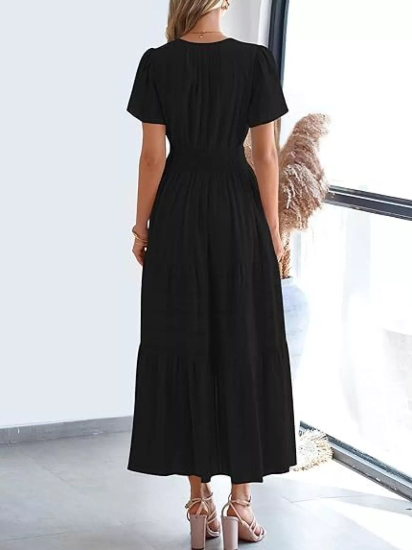 Black tiered midi dress with short sleeves and V-neck, smocked waist, rear view