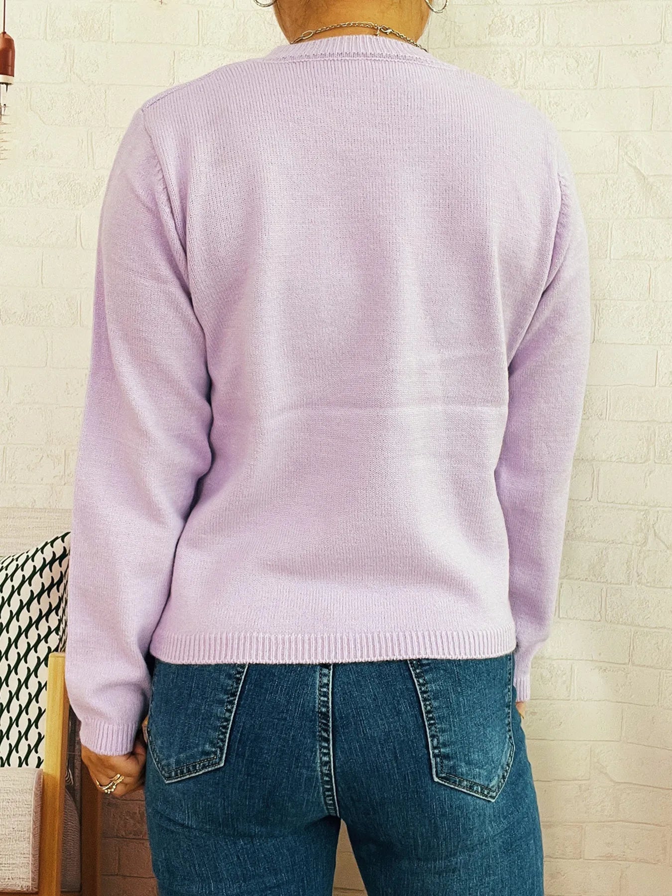 Purple knit sweater back view with ribbed round neck and long sleeves