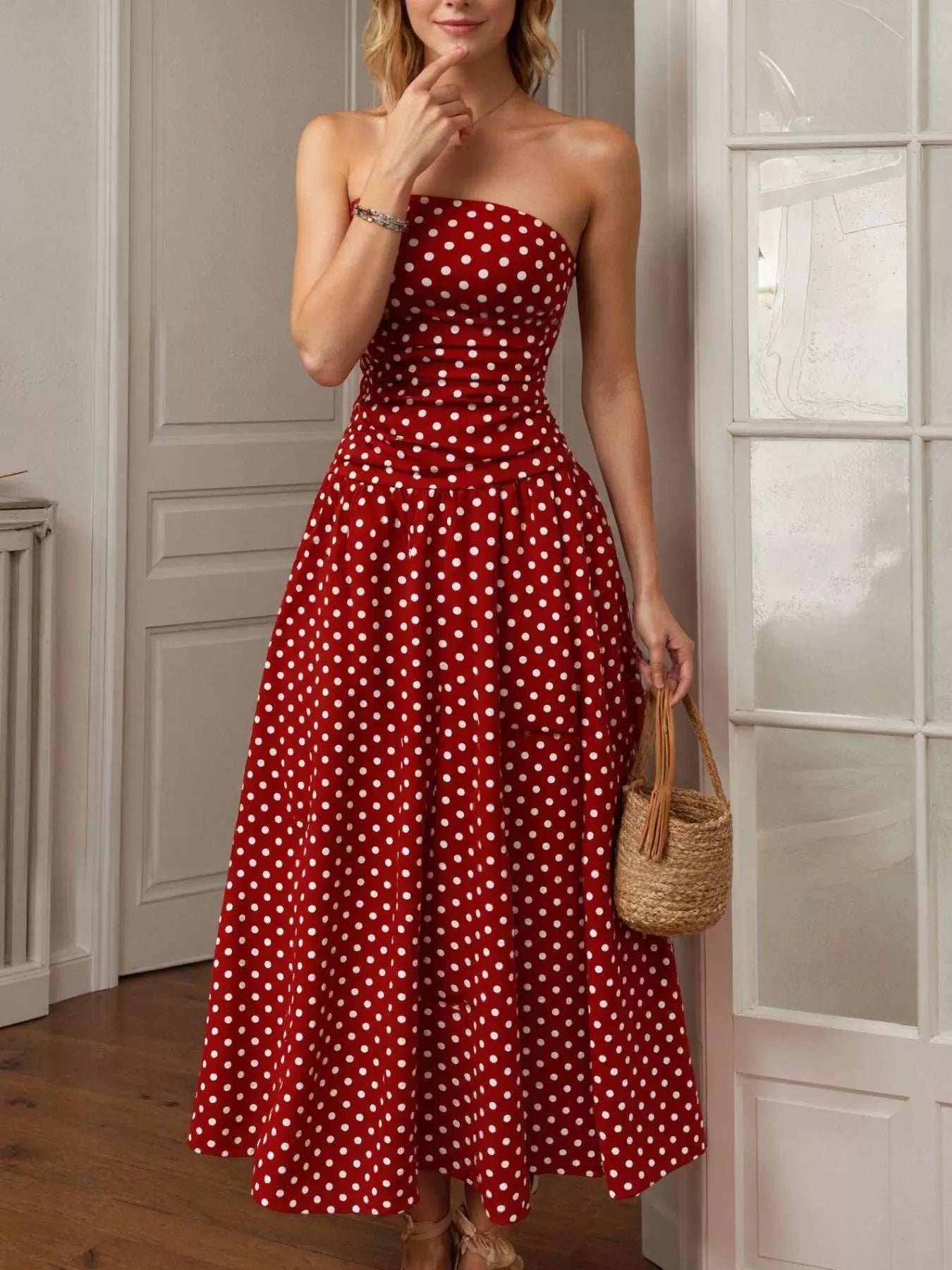 Red strapless maxi dress with white polka dots, fitted bodice and flared full skirt