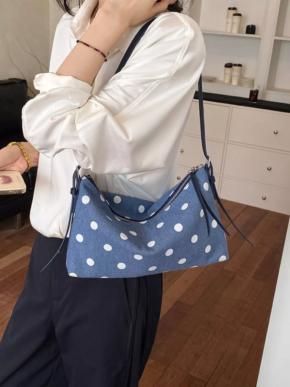 Small blue polka dot shoulder bag with zipper top and crossbody strap