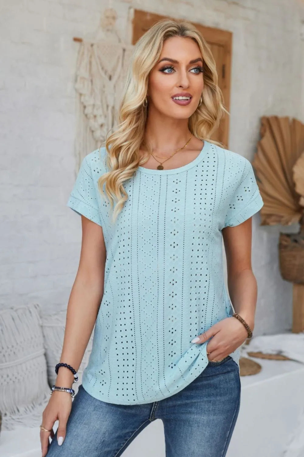 Light blue eyelet short-sleeve T-shirt with round neck and vertical dot pattern