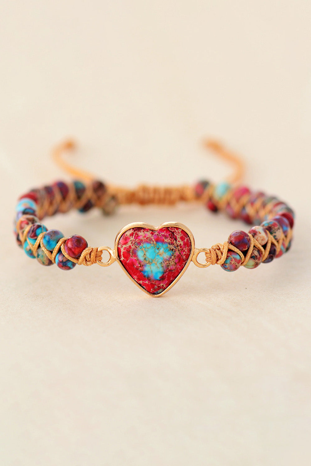 Multicolor braided bracelet with gold-tone clasp and red heart natural stone pendant