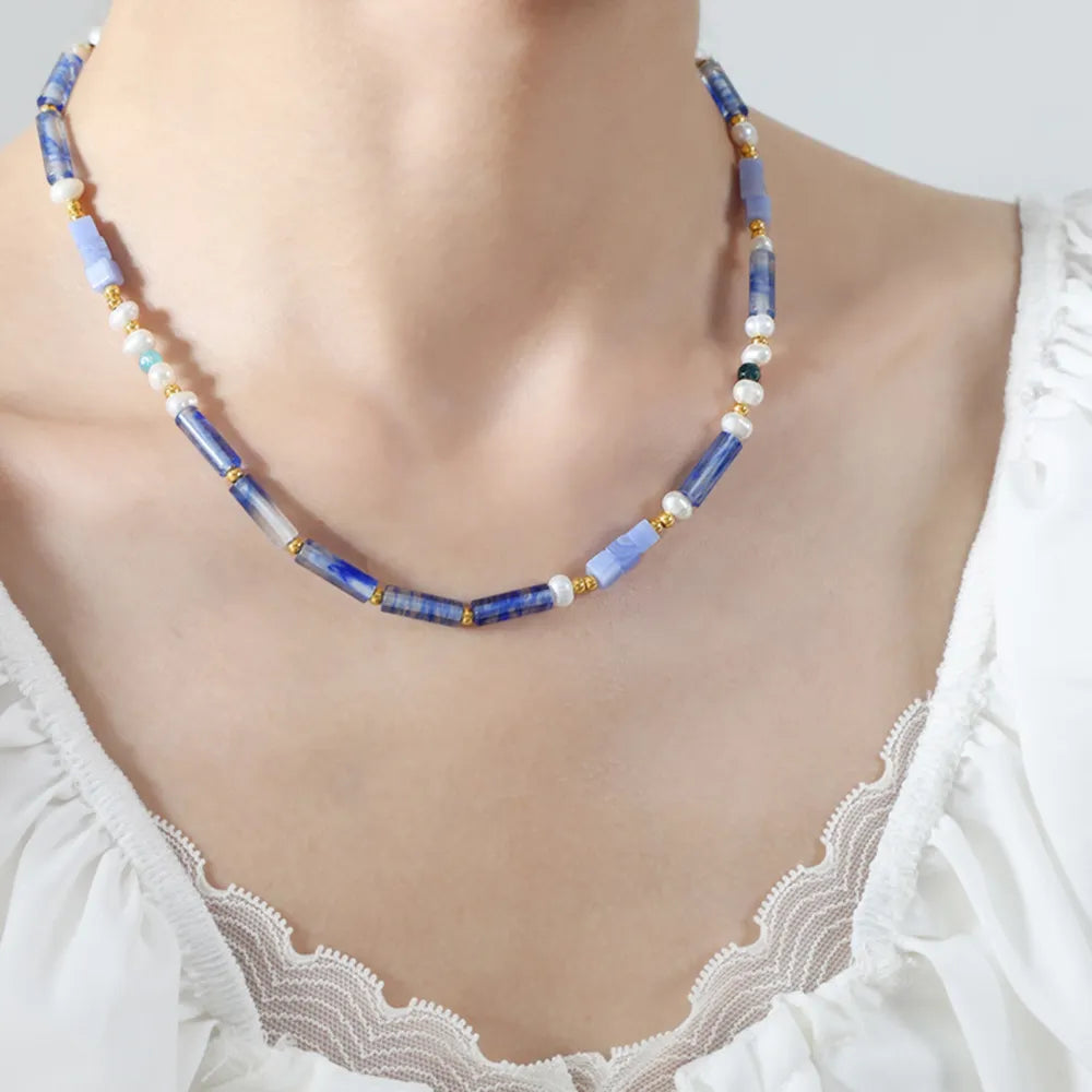 Freshwater pearl and blue geometric bead necklace with small gold accents