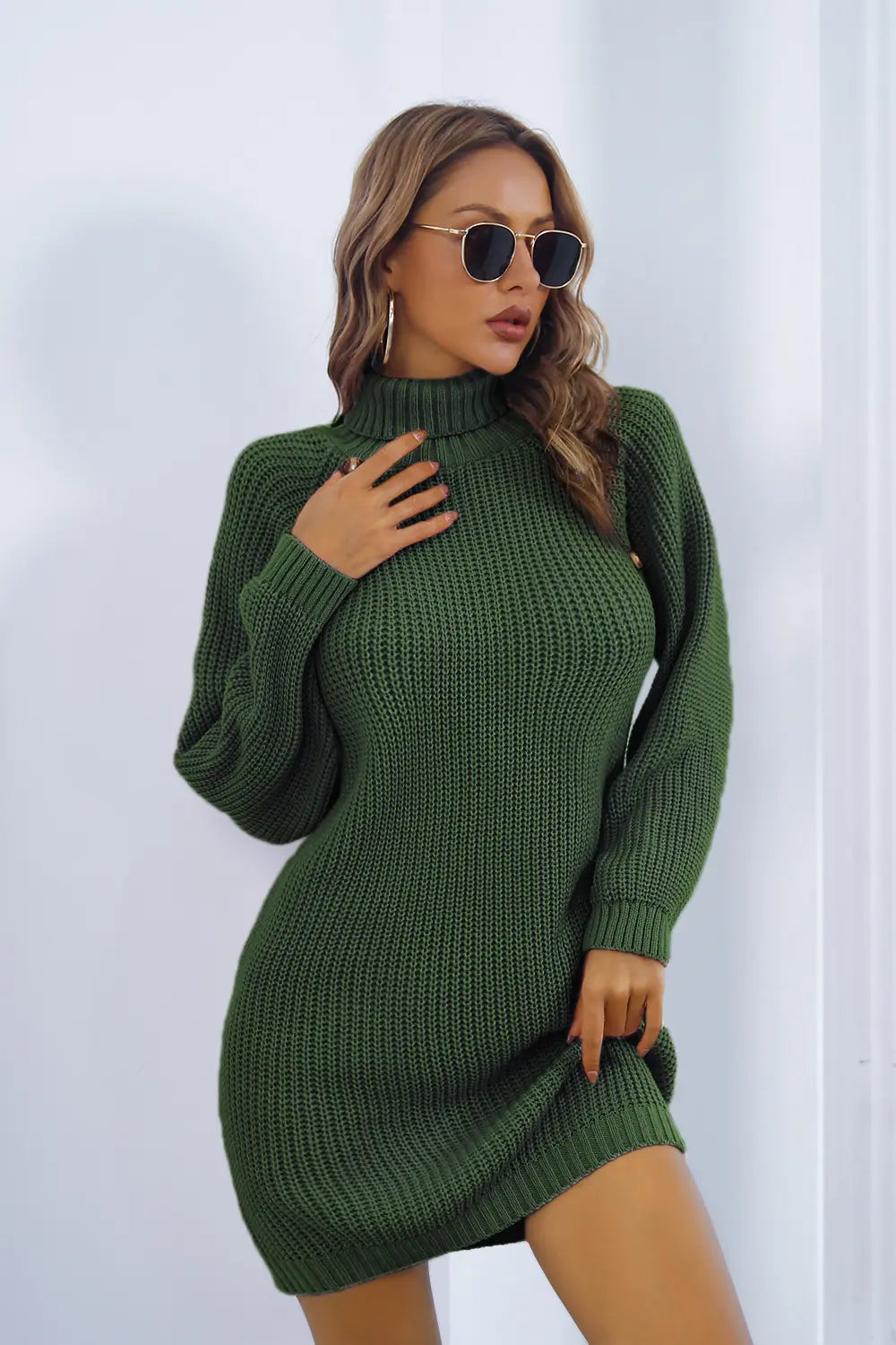 Green knit turtleneck sweater dress with long sleeves, side buttons and fitted shape