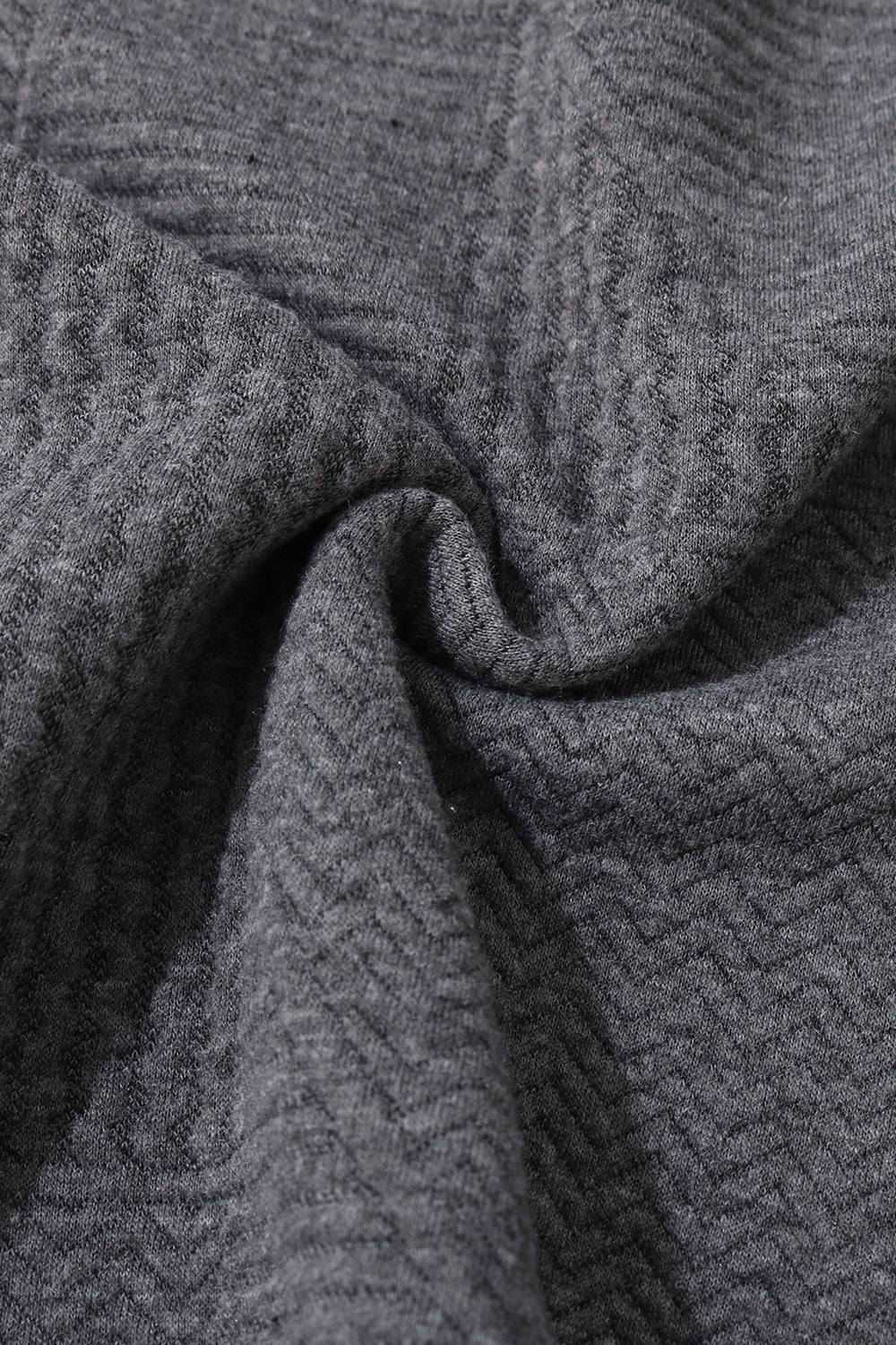 Charcoal textured knit fabric close-up with zigzag pattern