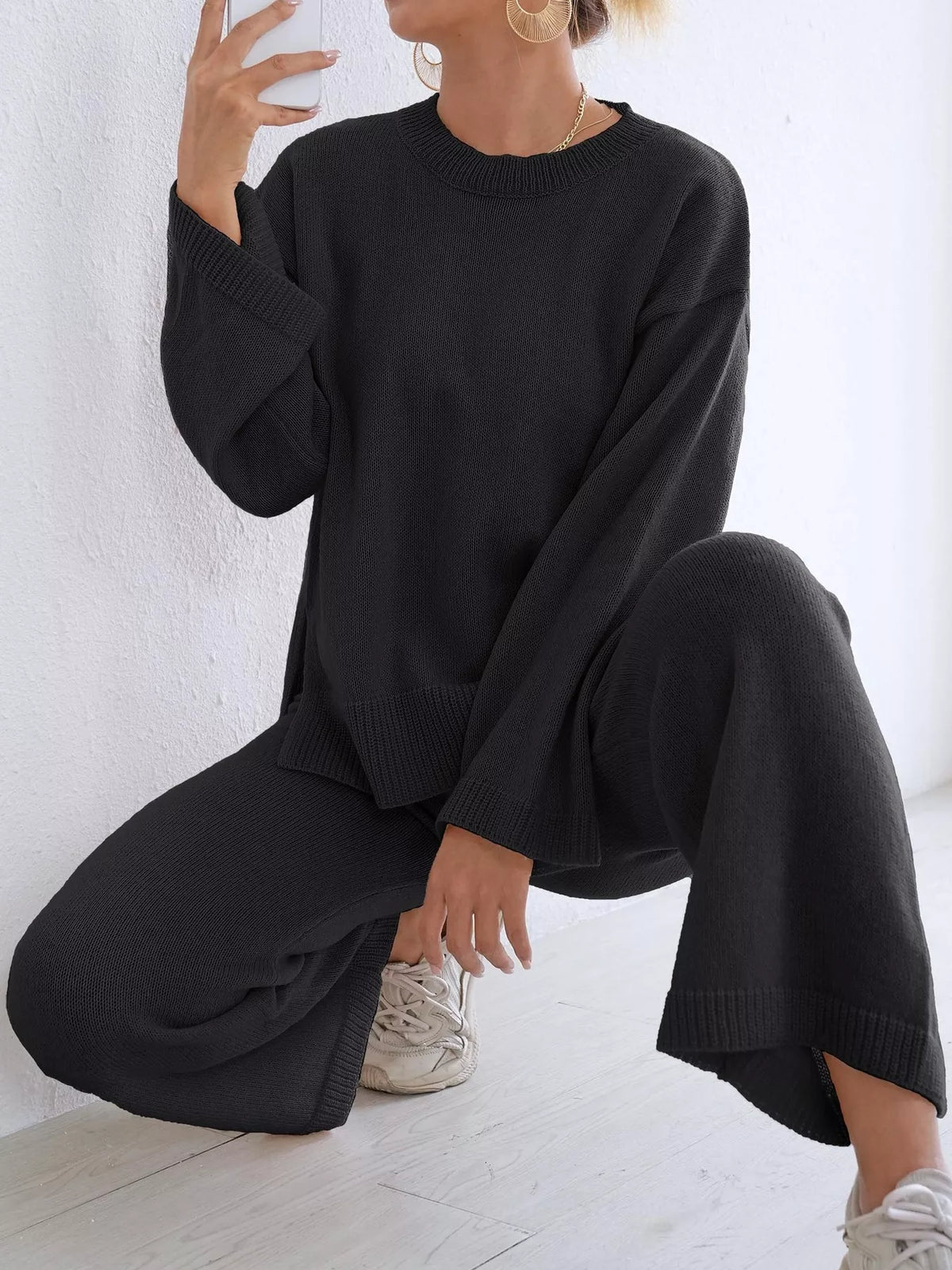 Black knit sweater with dropped sleeves and wide-leg pants, ribbed cuffs