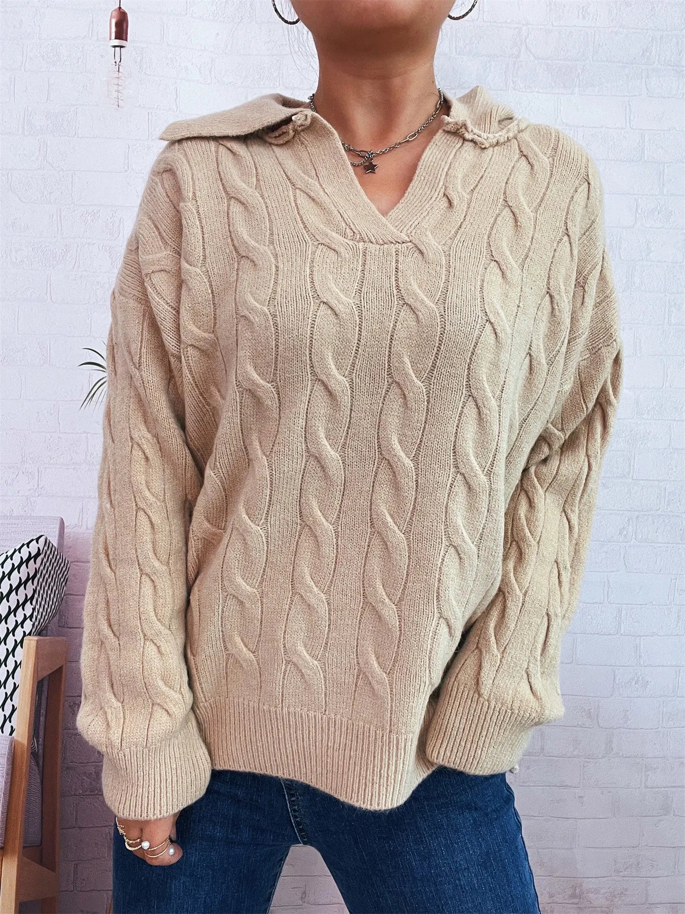 Beige cable-knit V-neck Johnny collar sweater with raised cable texture and ribbed cuffs