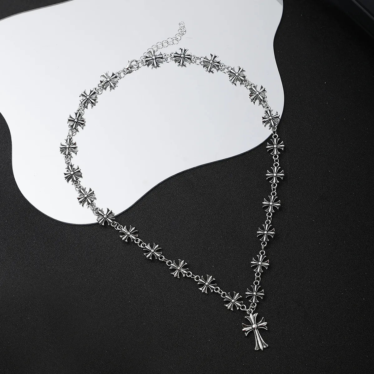 Silver cross pendant alloy necklace with repeating flower-like charms and central cross