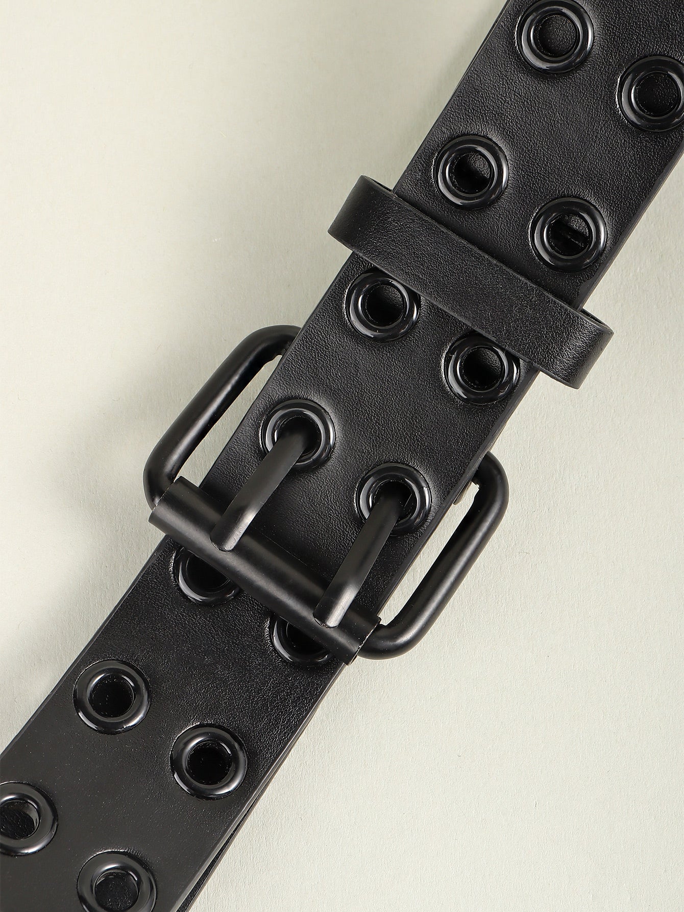 Black vegan leather grommet belt with rectangular buckle and punched holes