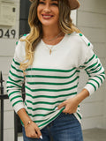 White pullover sweater with green horizontal stripes and green shoulder buttons