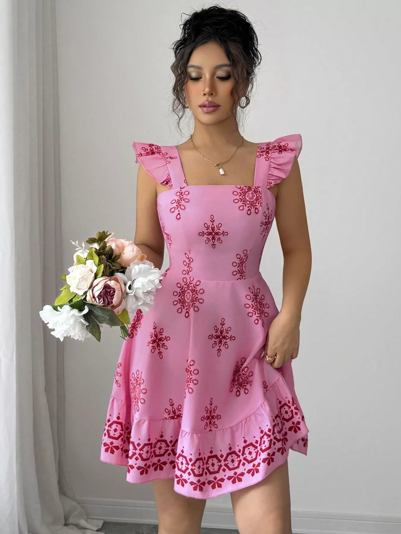 Pink printed mini dress with square neckline, ruffled cap sleeves, and flared hem