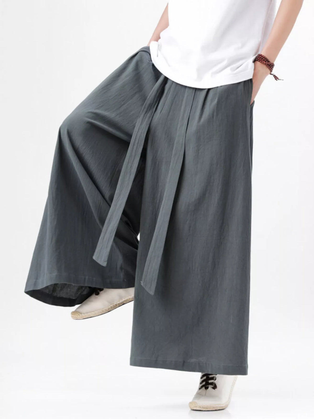 Gray wide-leg pants with cascading side drape and relaxed fit