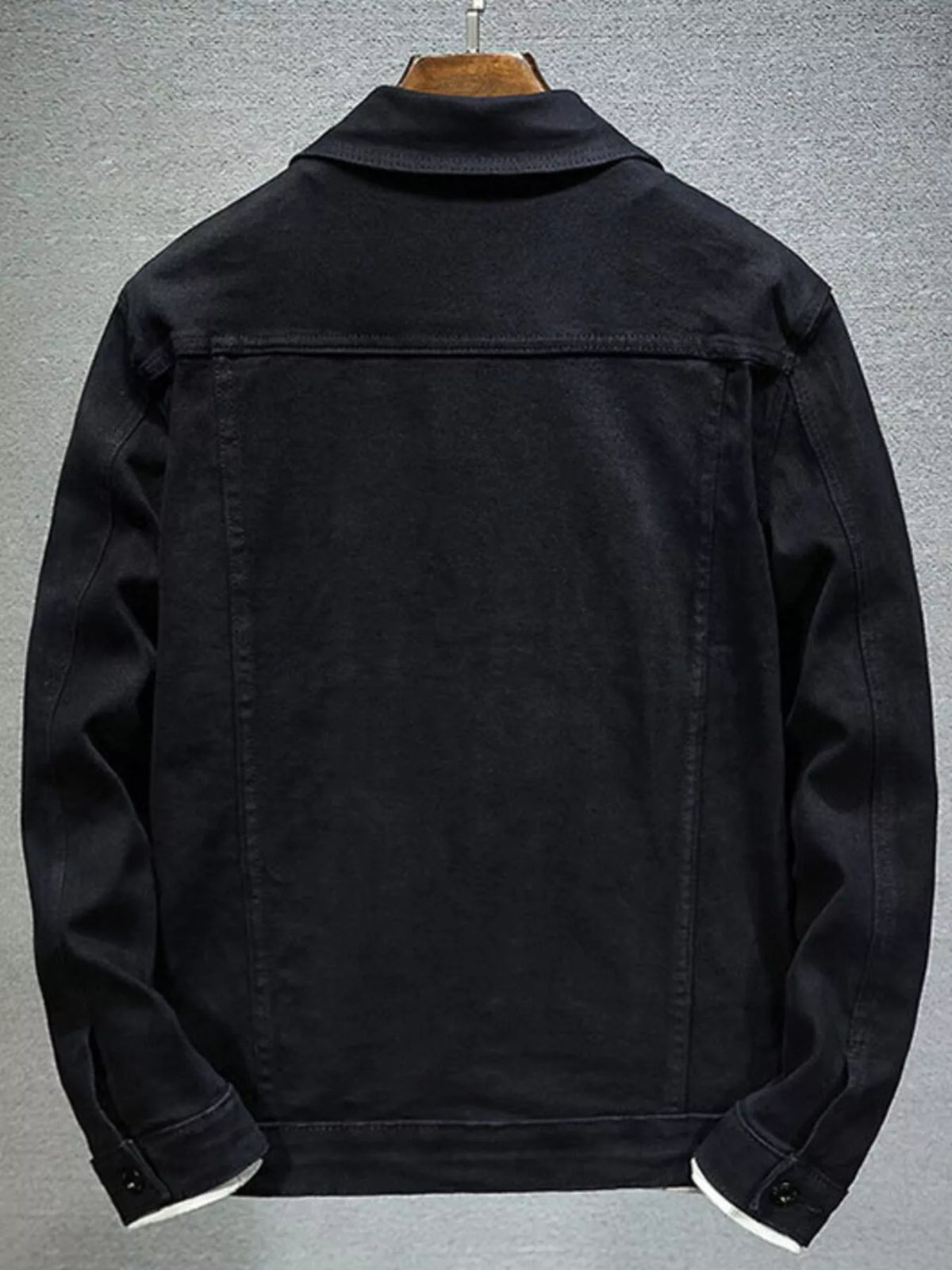 Black men’s denim button-up jacket, back view with yoke seam