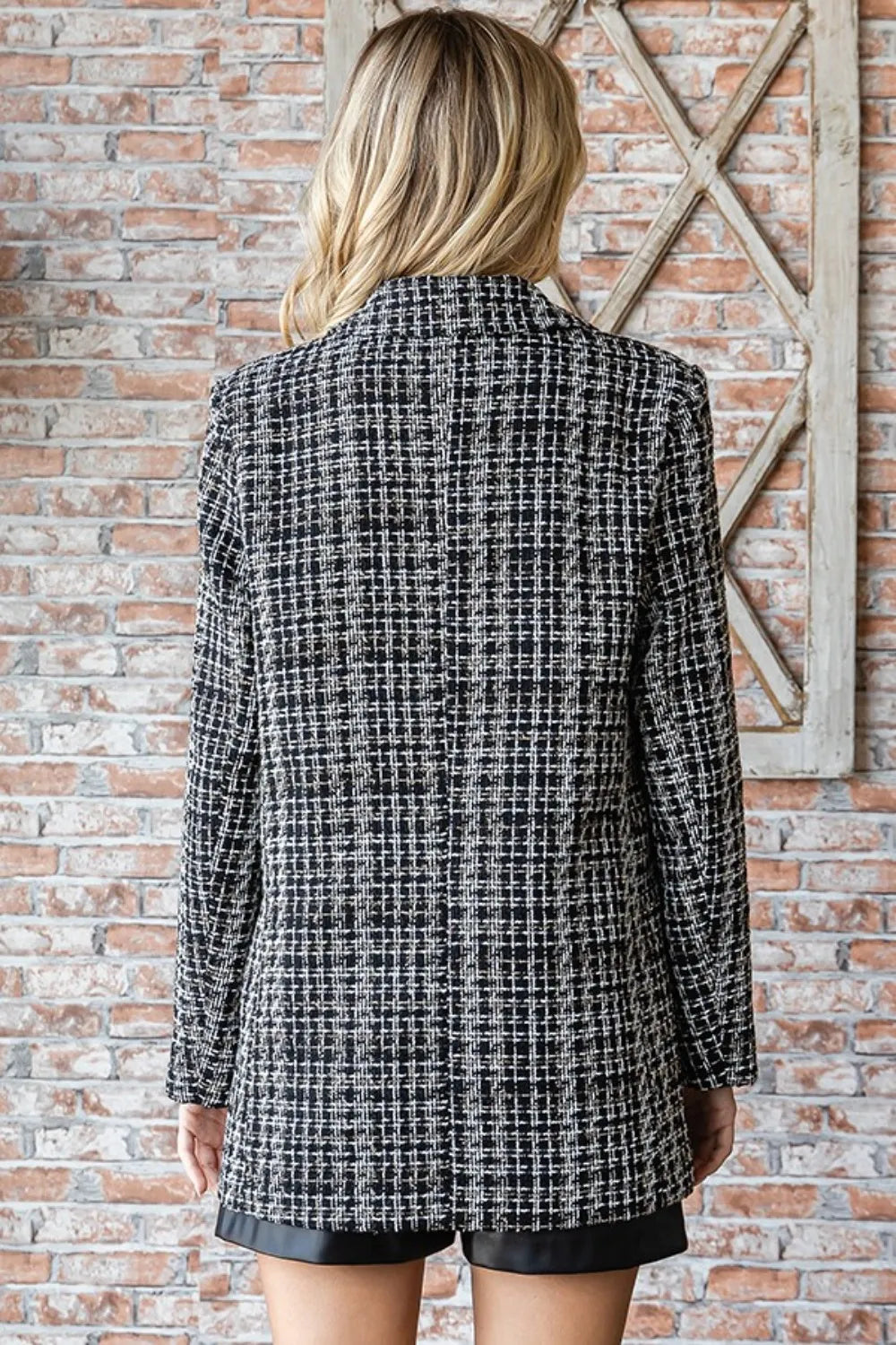 Back view of black-and-white tweed one-button blazer with long sleeves