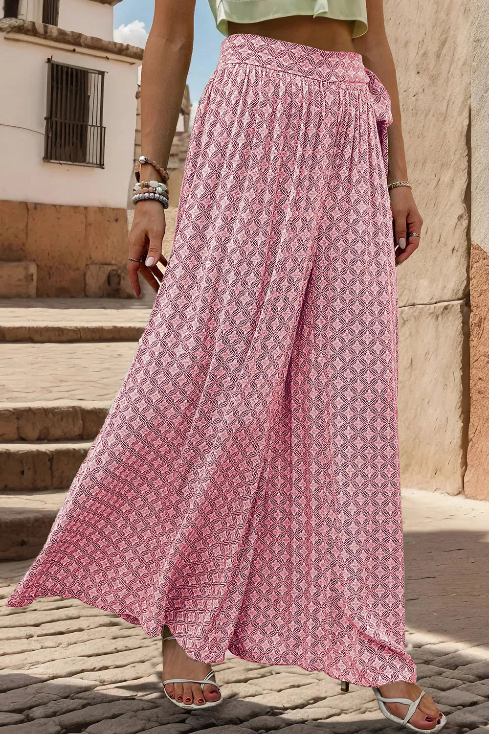 Pink printed wide-leg pants with tied waist detail, gathered top, and billowy wide legs