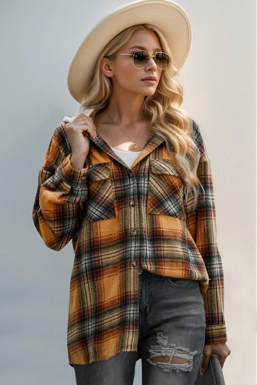 Orange plaid hooded shacket with drawstring hood and button-front closure