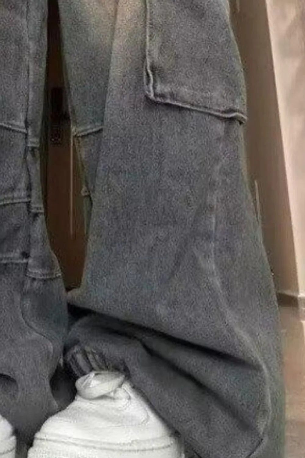 Wide-leg cargo jeans closeup, blue wash side pocket with flap and roomy leg opening