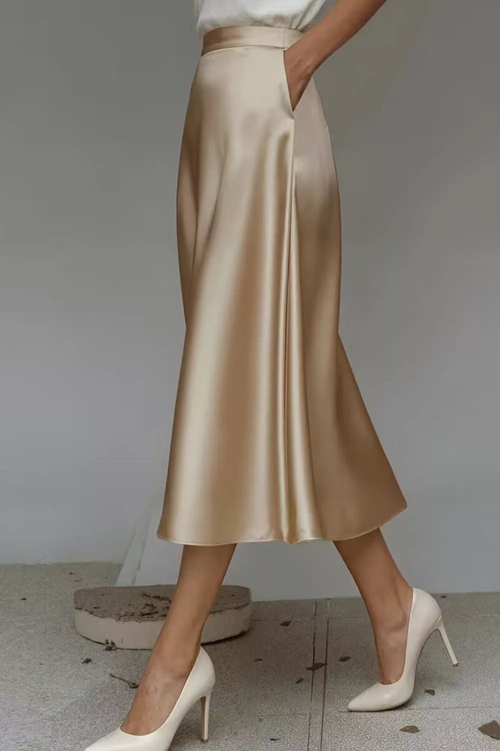 Satin A-line midi skirt in light gold with gathered A-line silhouette