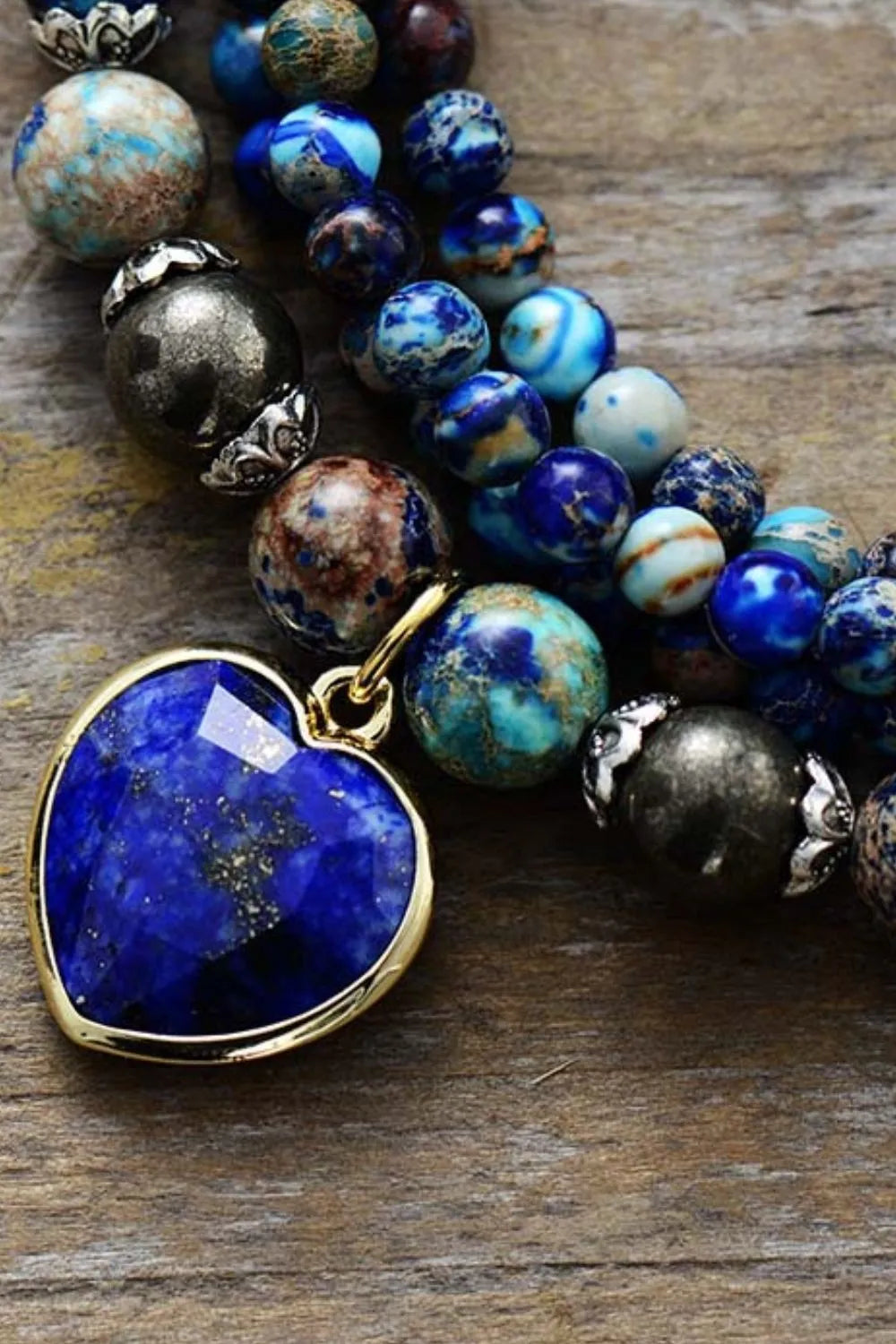 Three-strand bracelet with large blue heart pendant and mixed stone beads