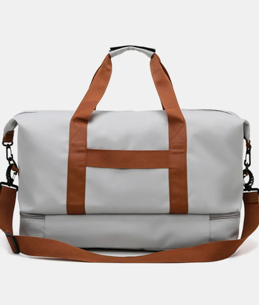 Oversize travel duffle bag in light gray with brown long handles and striped front panel
