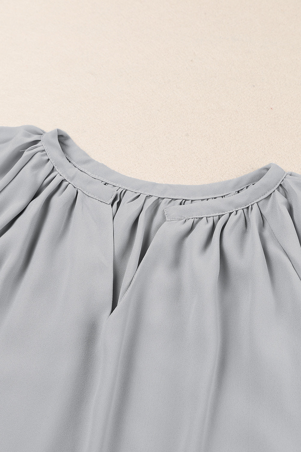 Dusty blue gathered notched neckline flutter sleeve blouse close-up