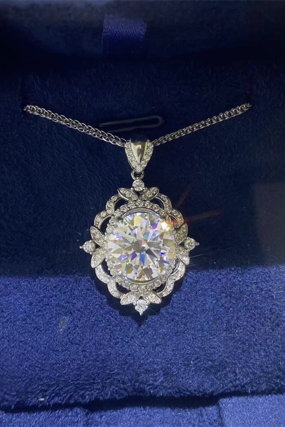 Sterling silver moissanite pendant necklace with round center stone and halo setting