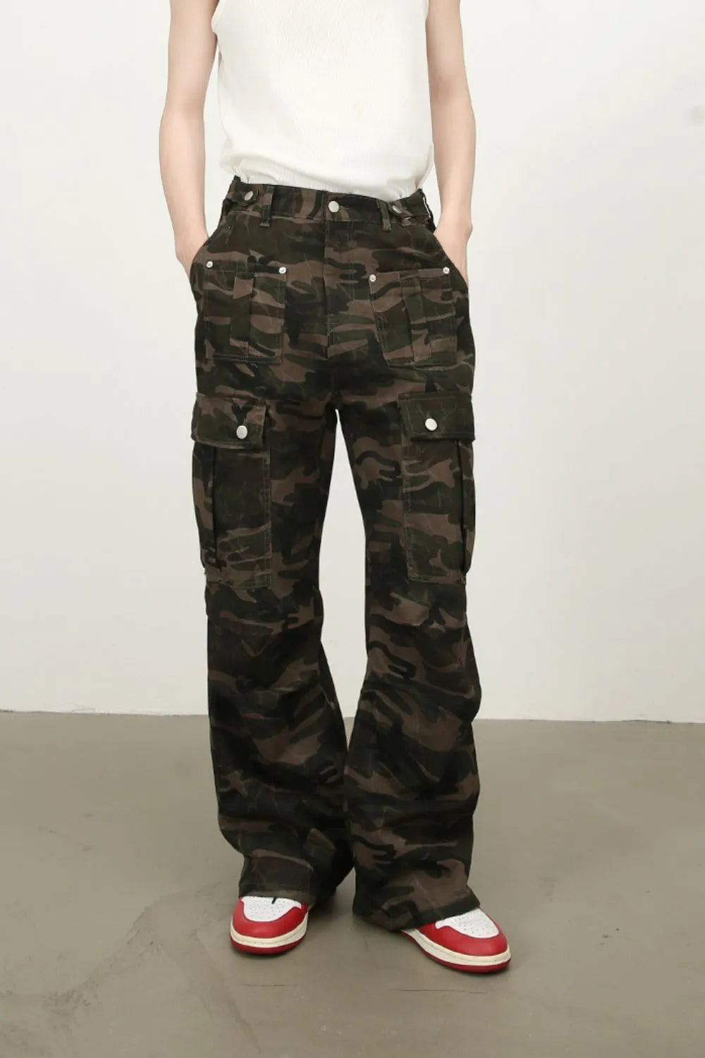Men's green camouflage cargo jeans with front flap pockets and button waist