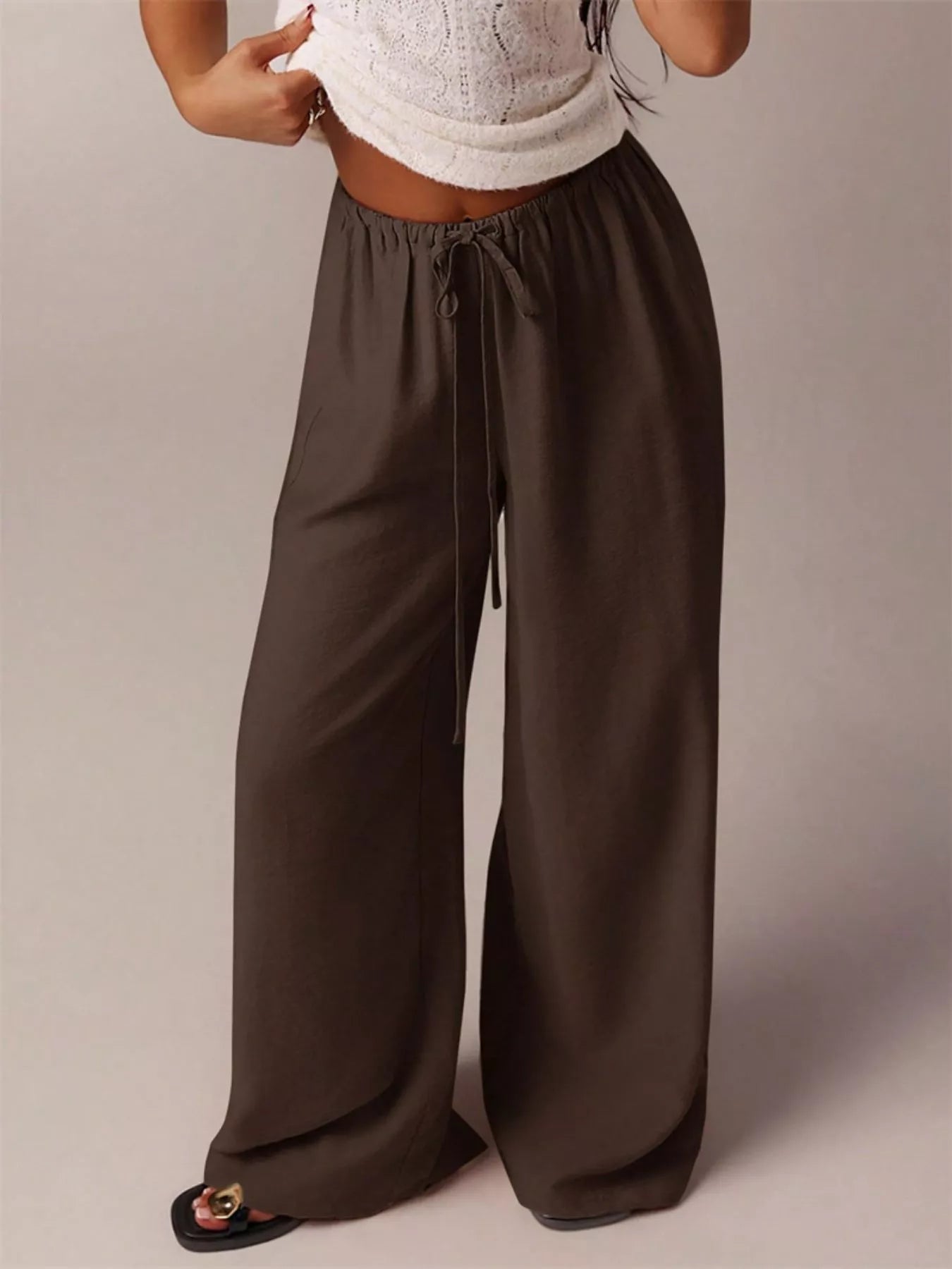 Dark brown drawstring wide-leg pants with elastic waist and flowing wide legs
