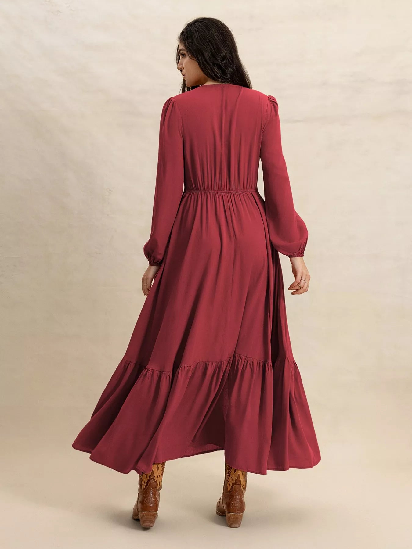 Back view of burgundy V-neck maxi dress with gathered waist and tiered skirt hem